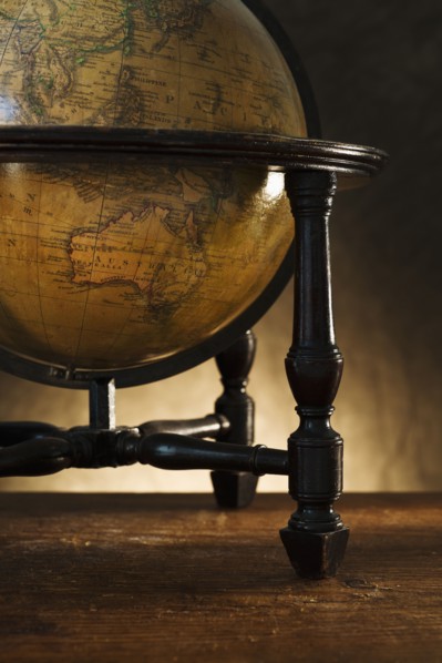 Close up of antique globe on table.