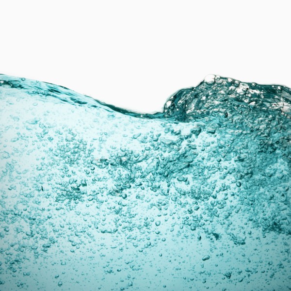 Water with bubbles on white background. Photo : Joe Clark