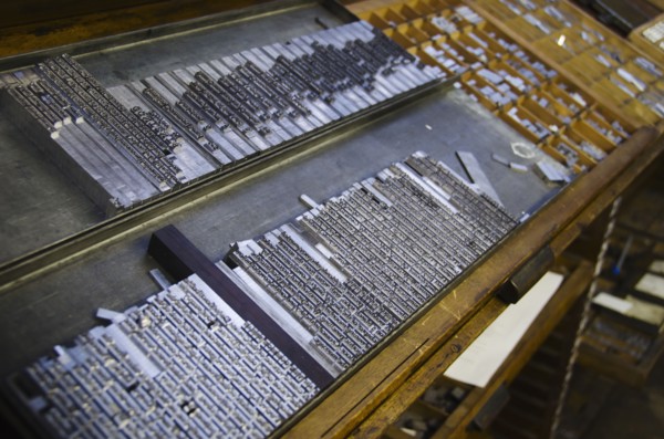 Printing plates on antique printing press.