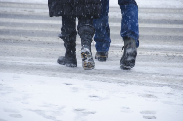 USA, New York City, Pedestrians crossing road in blizzard.