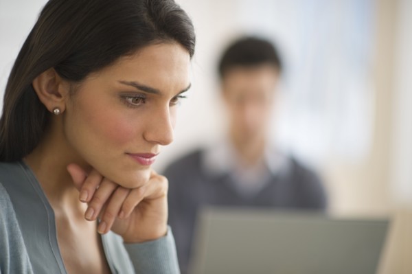 Business woman with hand on chin.