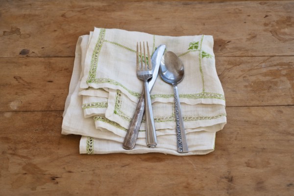 Close up of silverware on dish towel.