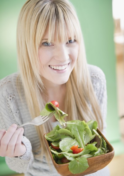 Young woman eating salad. Photo: Jamie Grill Photography
