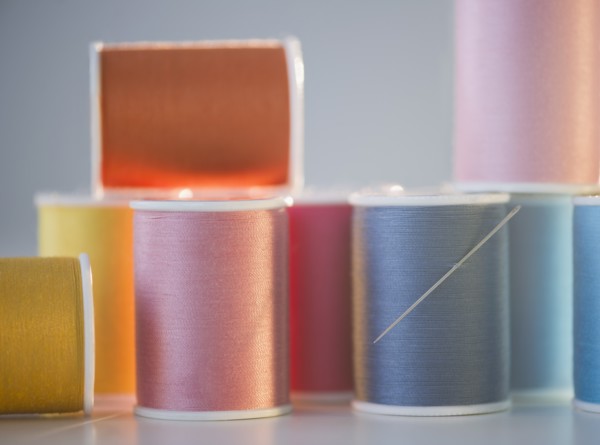 Spools with colorful threads. Photo : Jamie Grill Photography