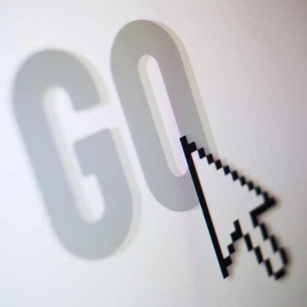 Studio shot of arrow cursor on go button. Photo : Jamie Grill Photography