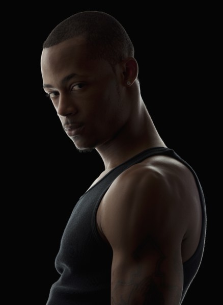 Studio portrait of muscular young man wearing tank top. Photo : Mike Kemp