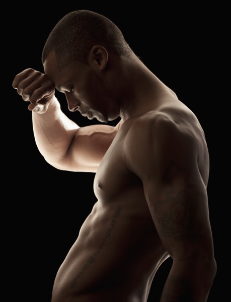 Studio shot of tired shirtless man. Photo : Mike Kemp