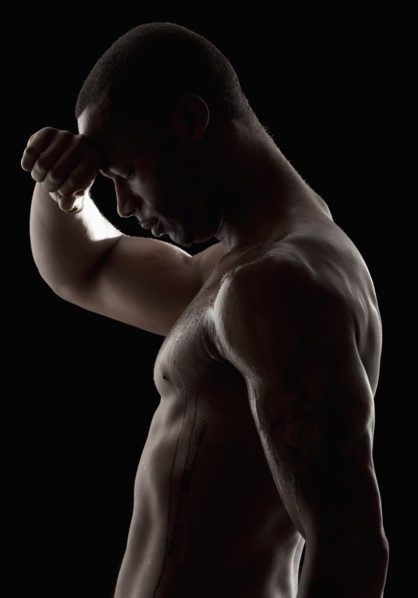 Studio shot of tired shirtless man. Photo : Mike Kemp