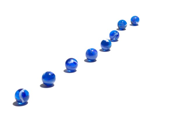 Blue glass balls in a row. Photo : David Arky