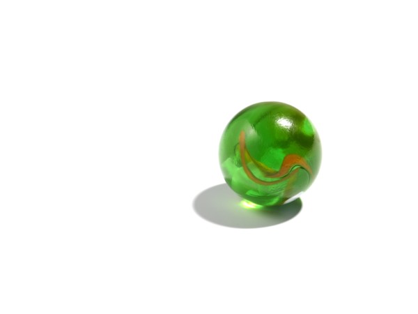 Studio shot of small green glass ball. Photo : David Arky