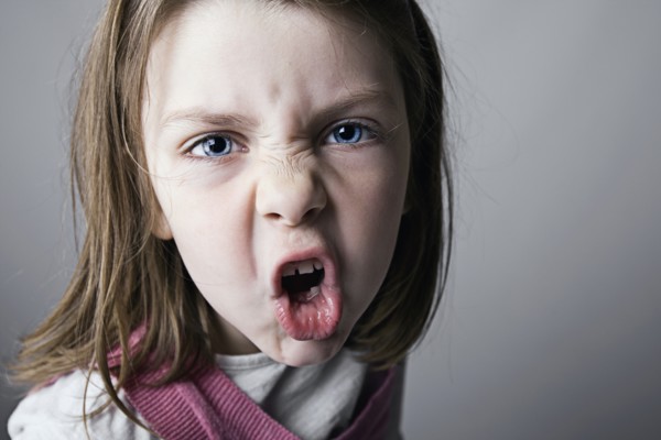 Close-up of girl (6-7) shouting. Photo : Justin Paget