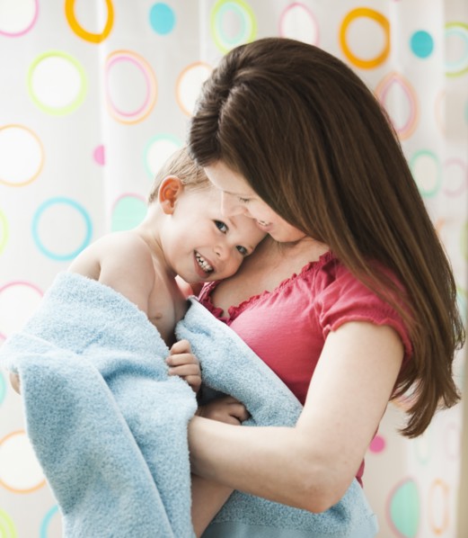 Mother with son (2-3) wrapped in towel. Photo : Mike Kemp