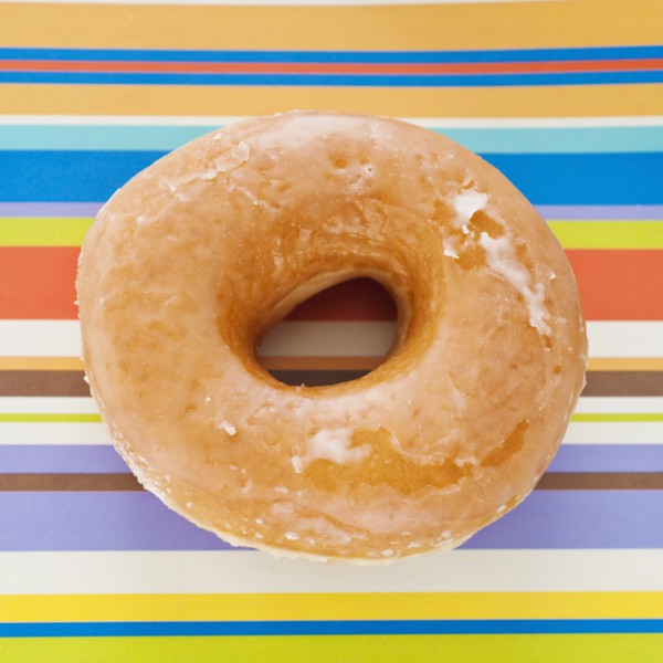 Studio shot of donut on striped background.