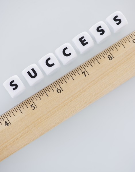 Studio shot of ruler and dice spelling out success. Photo: Daniel Grill