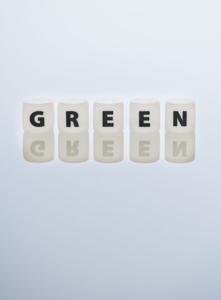 Studio shot of dice spelling out green. Photo: Daniel Grill