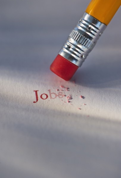 Studio shot of pencil erasing the word jobs from piece of paper. Photo : Daniel Grill
