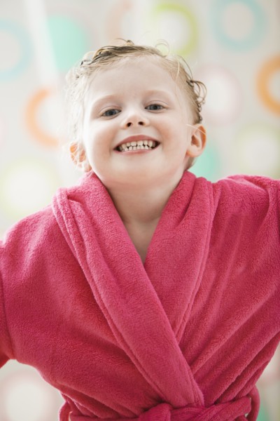 Portrait of girl (2-3) wrapped in bathrobe. Photo : Mike Kemp