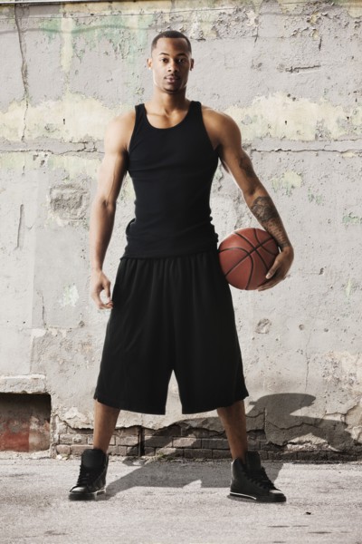 USA, Utah, Salt Lake City, Portrait of young man with basketball against dilapidated wall. Photo :