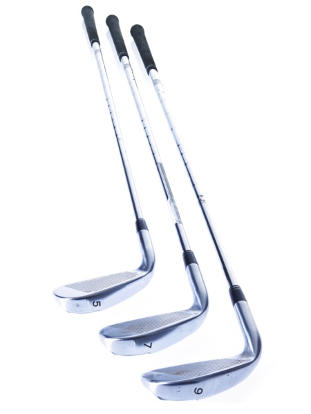 Three golf clubs on white background. Photo : David Arky