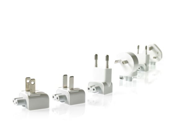 Row of plugs on white background. Photo : David Arky