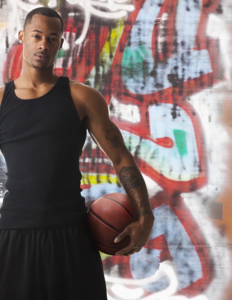 USA, Utah, Salt Lake City, portrait of basketball player in front of graffiti. Photo: Mike Kemp