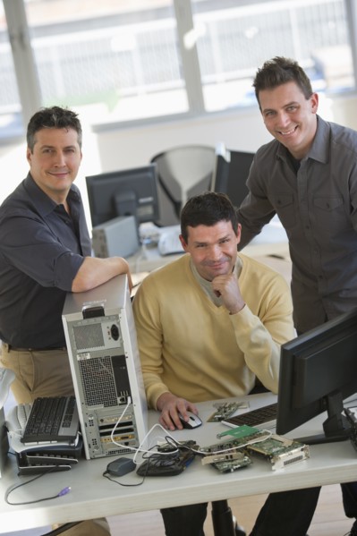 IT Professionals repairing computer in office.