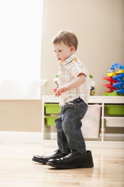 Boy (2-3) walking in dad's shoes. Photo: Mike Kemp