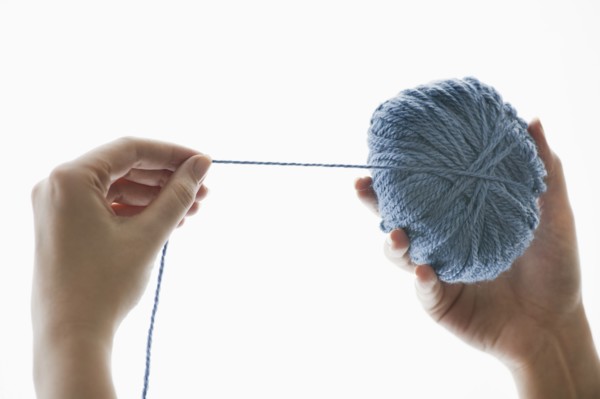 Studio shot of woman with ball of wool.