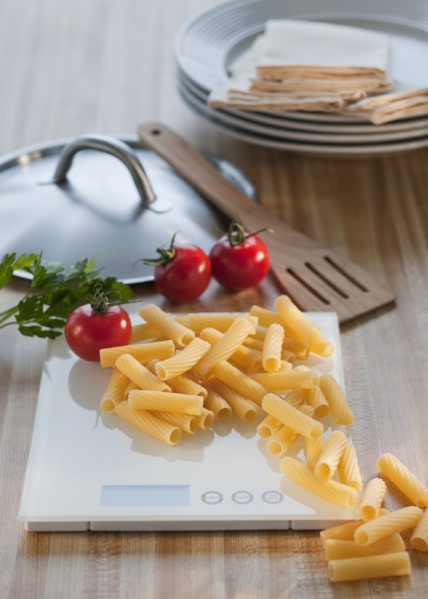 Raw pasta on weight scale.