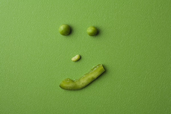 Anthropomorphic face made up from green peas. Photo: Kristin Lee