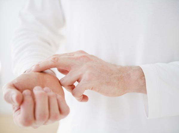 Hands taking pulse. Photo : Jamie Grill Photography