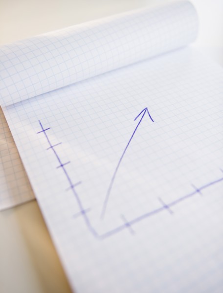 Studio shot of arrow graph in notepad. Photo : Jamie Grill Photography