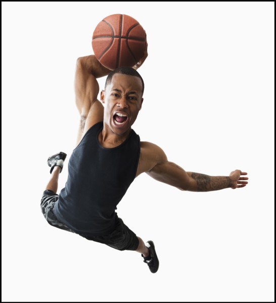 Studio shot of young man playing basketball. Photo : Mike Kemp