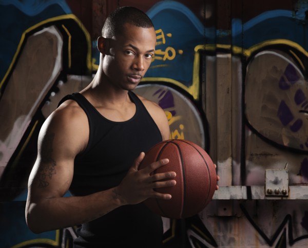 Portrait of young man with basketball. Photo : Mike Kemp