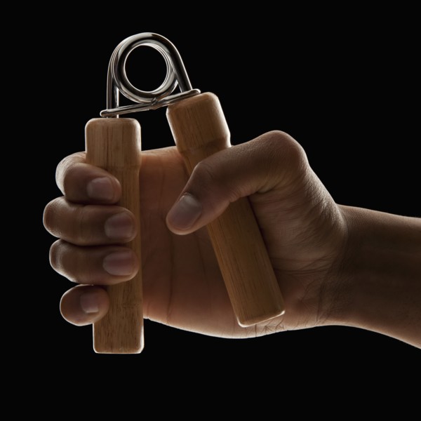 Studio shot of young man's hand exercising. Photo: Mike Kemp
