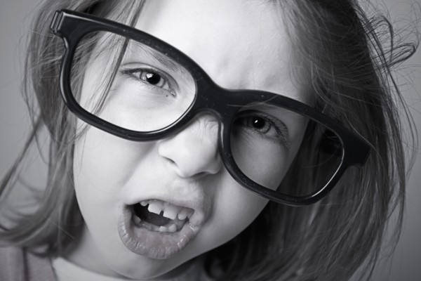 Close-up of girl (6-7) shouting. Photo : Justin Paget