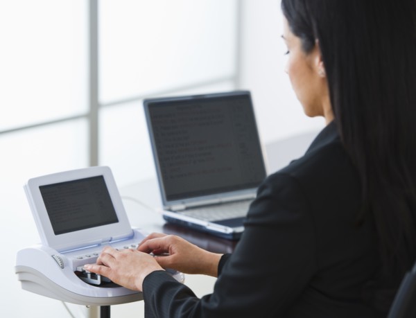 Court stenographer using stenograph machine. Photo: Daniel Grill