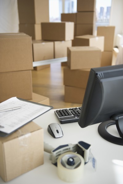 Boxes and computer at delivery warehouse.