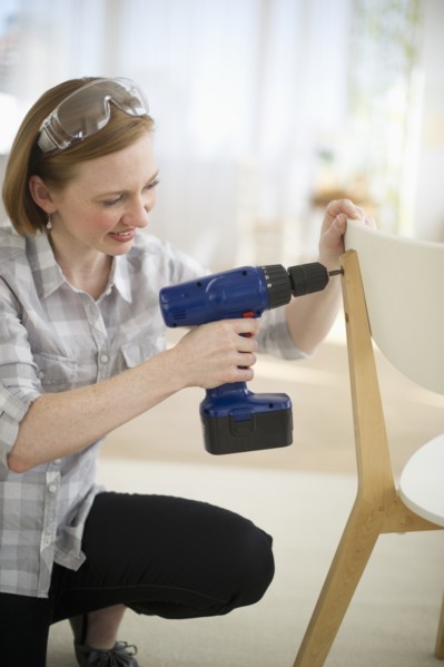 Woman repairing chair.