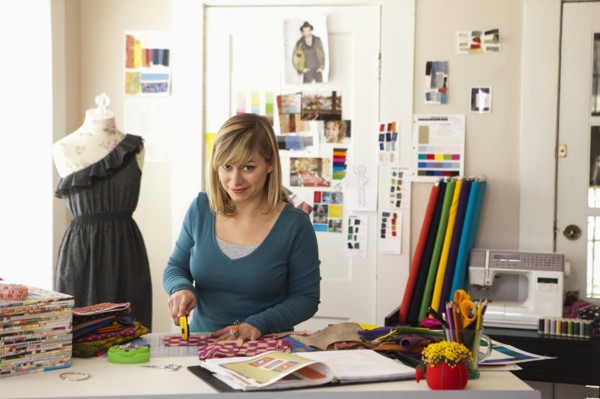 Female fashion designer working in studio. Photo : DreamPictures
