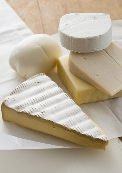 Various cheeses on table.