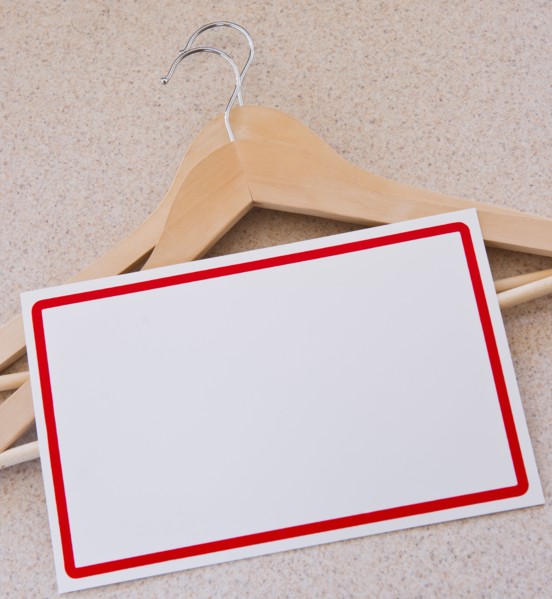 Blank price tag and coat hangers. Photo : Daniel Grill