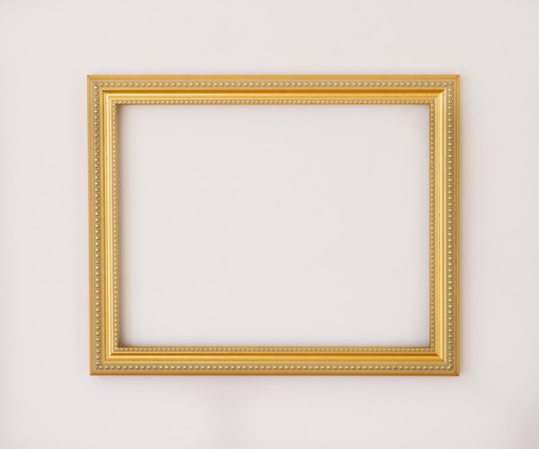 Studio shot of golden picture frame on white background. Photo : Daniel Grill