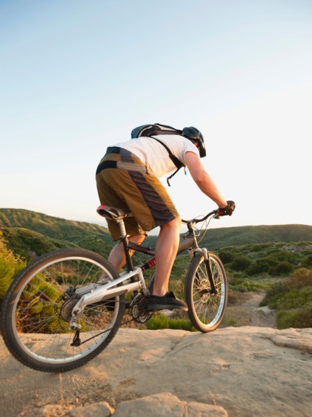 USA, California, Laguna Beach, Man cycling down hill.