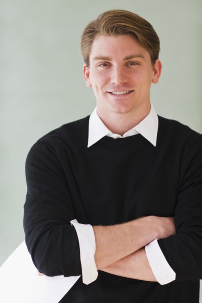 portrait of young teacher standing in front of blackboard. Photo : Daniel Grill