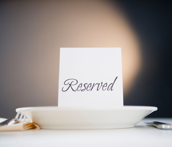 Reserved sign on place setting, studio shot. Photo : Jamie Grill Photography