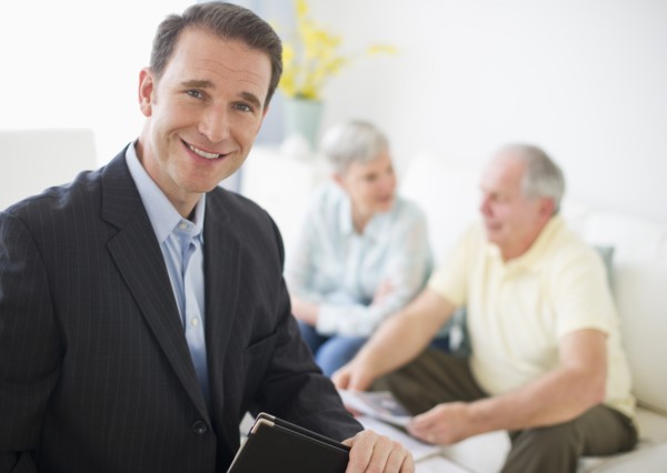 Portrait of businessman, senior couple in the background.
