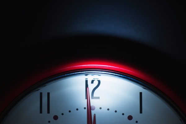 Close up of clock face showing midnight.