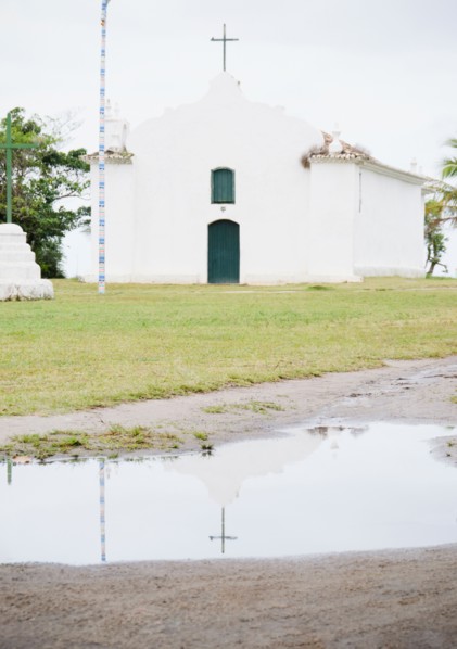 Brazil, Bahia, Trancoso, Church reflecting in puddle. Photo : Jamie Grill Photography