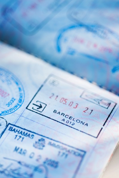 Close up of page from passport with stamps.